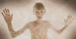 Defocused view of a boy behind a glass window